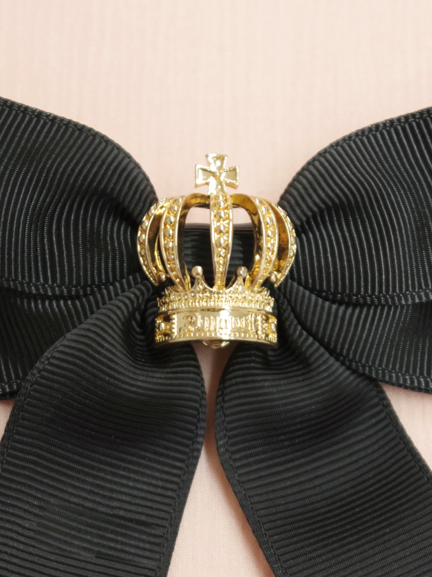 Ribbon brooch with crown charm