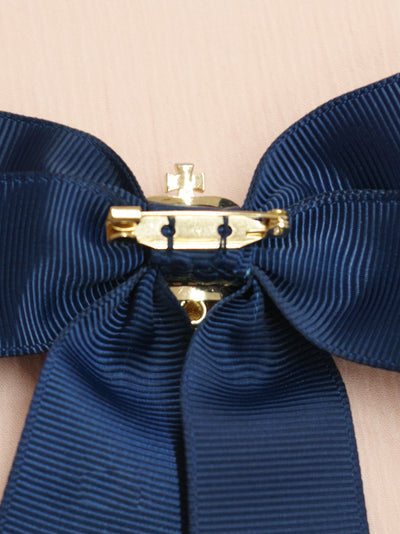 Ribbon brooch with crown charm