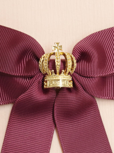 Ribbon brooch with crown charm