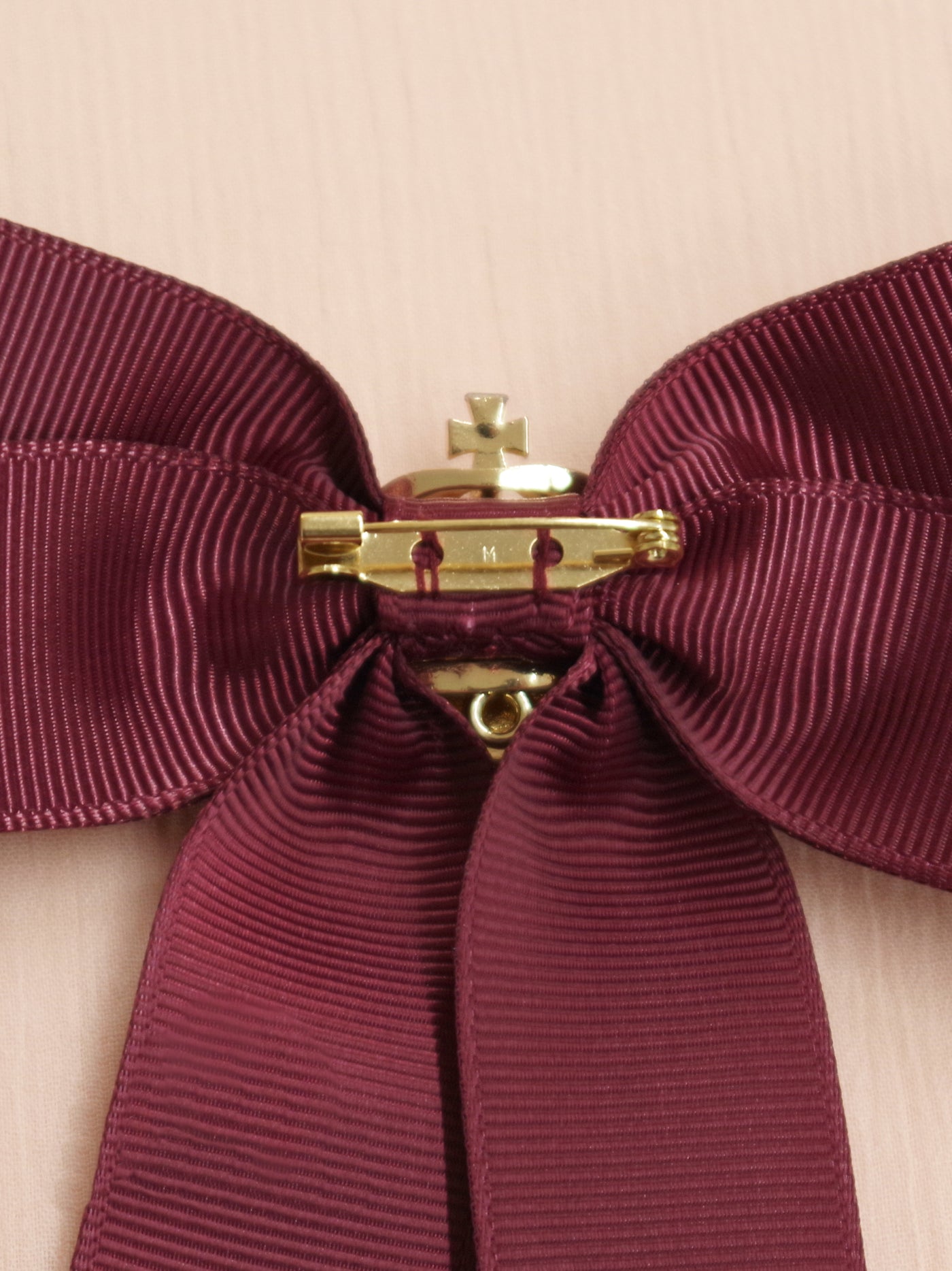 Ribbon brooch with crown charm