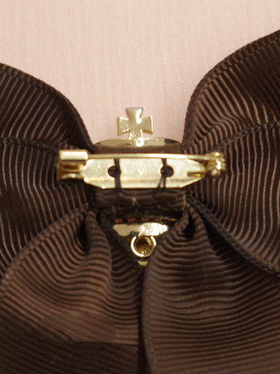 Ribbon brooch with crown charm