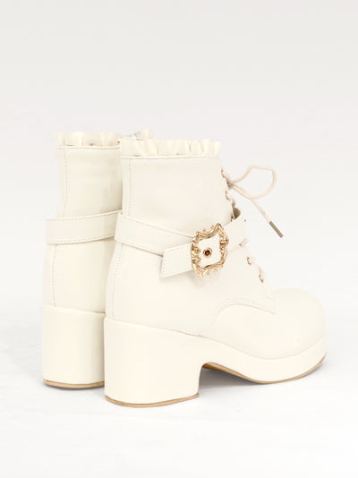 Monogram embossed frilled short boots